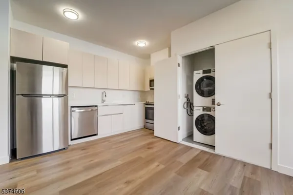 a view of a kitchen with a washer and dryer