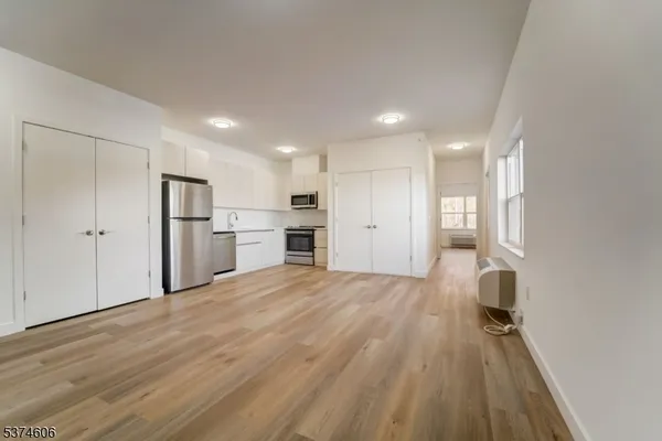a view of a kitchen with a sink and wooden floor