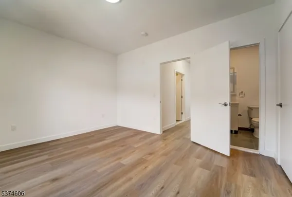 a view of an empty room and wooden floor