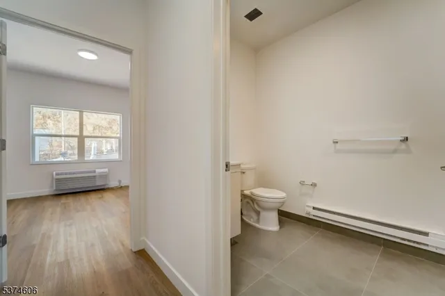 a bathroom with a toilet a sink and a window