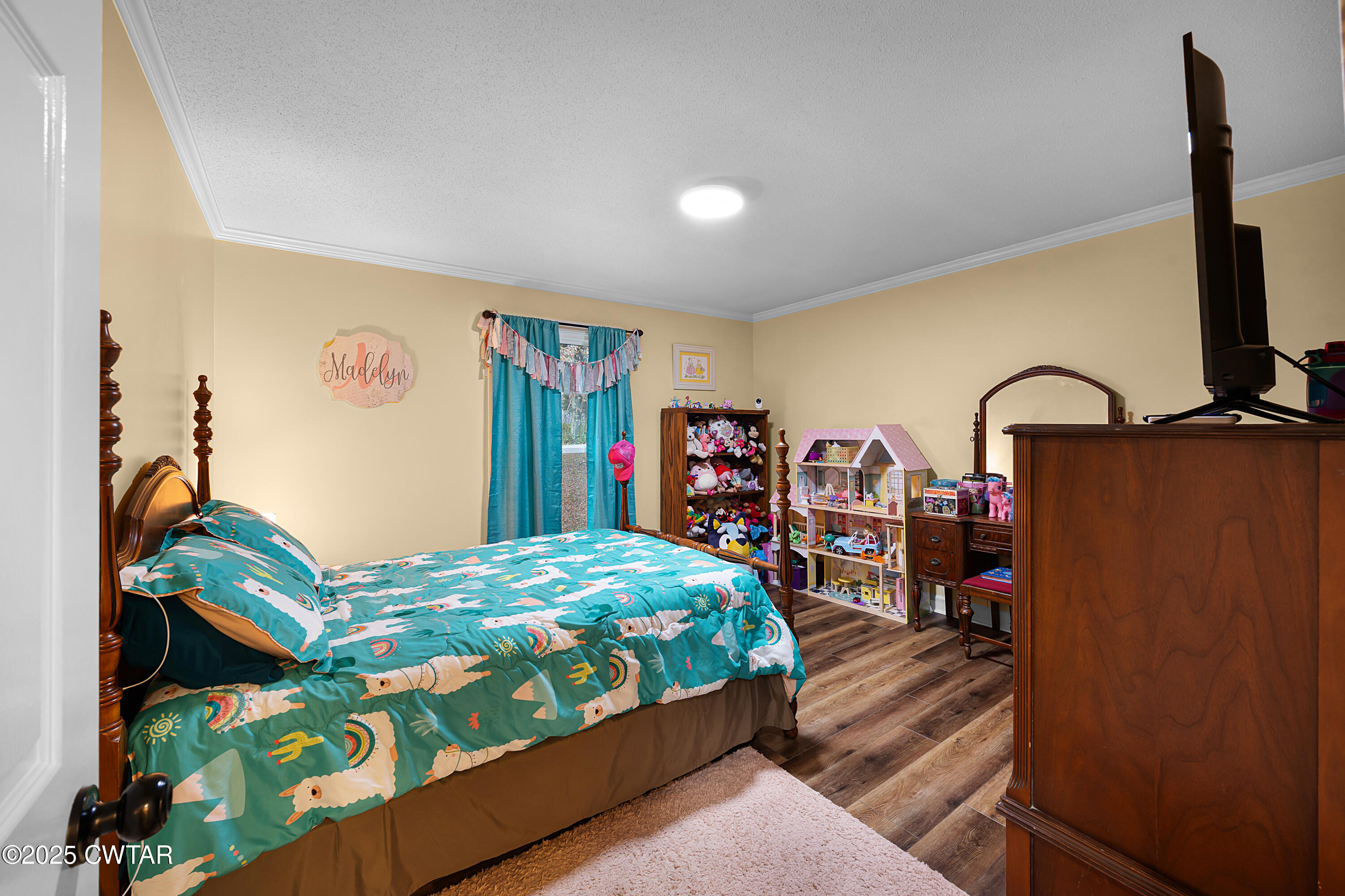 185 Bascom Road Jackson, TN 38305 - Photo 16 of 28 a bedroom with a bed and a large mirror on the dresser