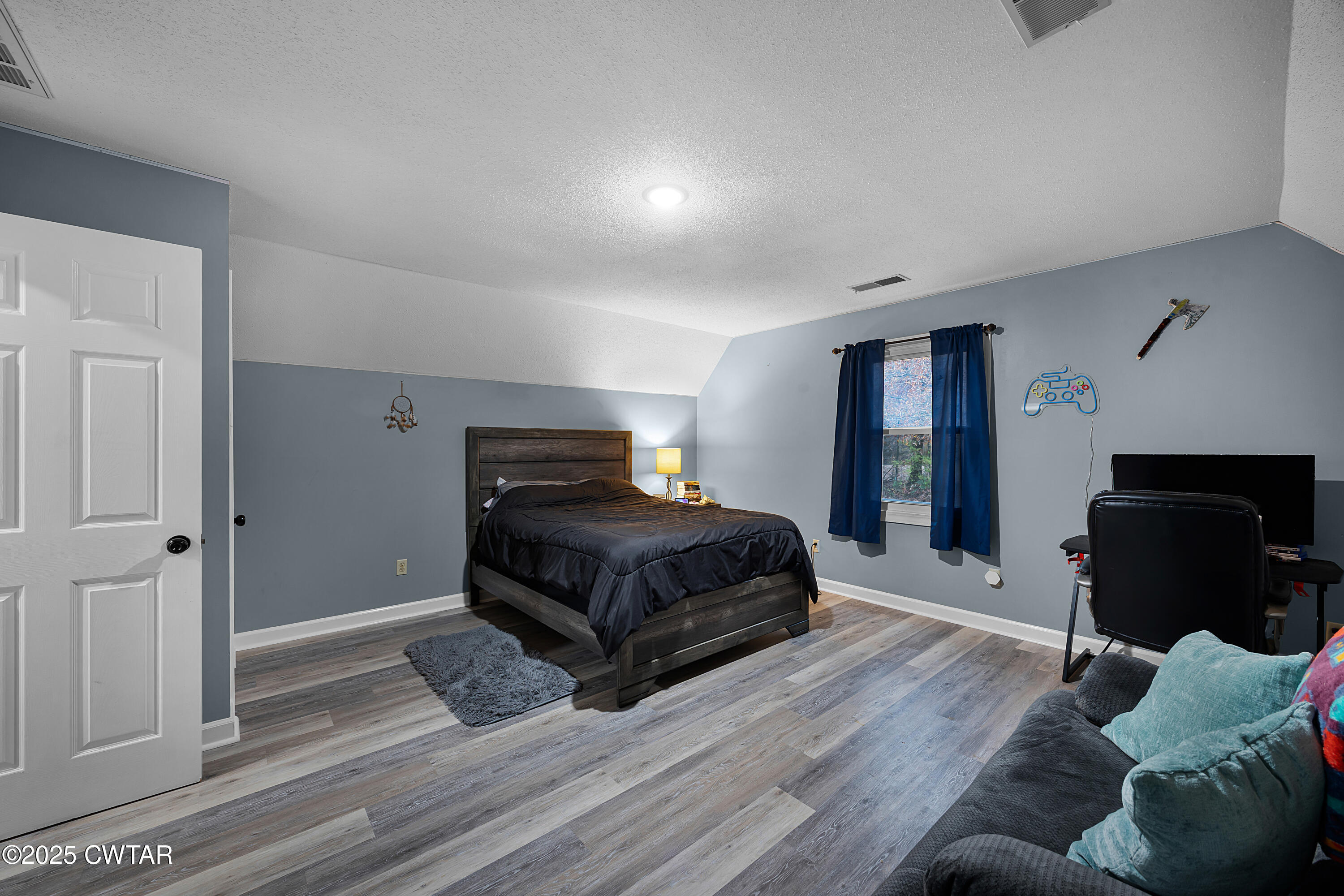 185 Bascom Road Jackson, TN 38305 - Photo 19 of 28 a bedroom with a bed and wooden floor