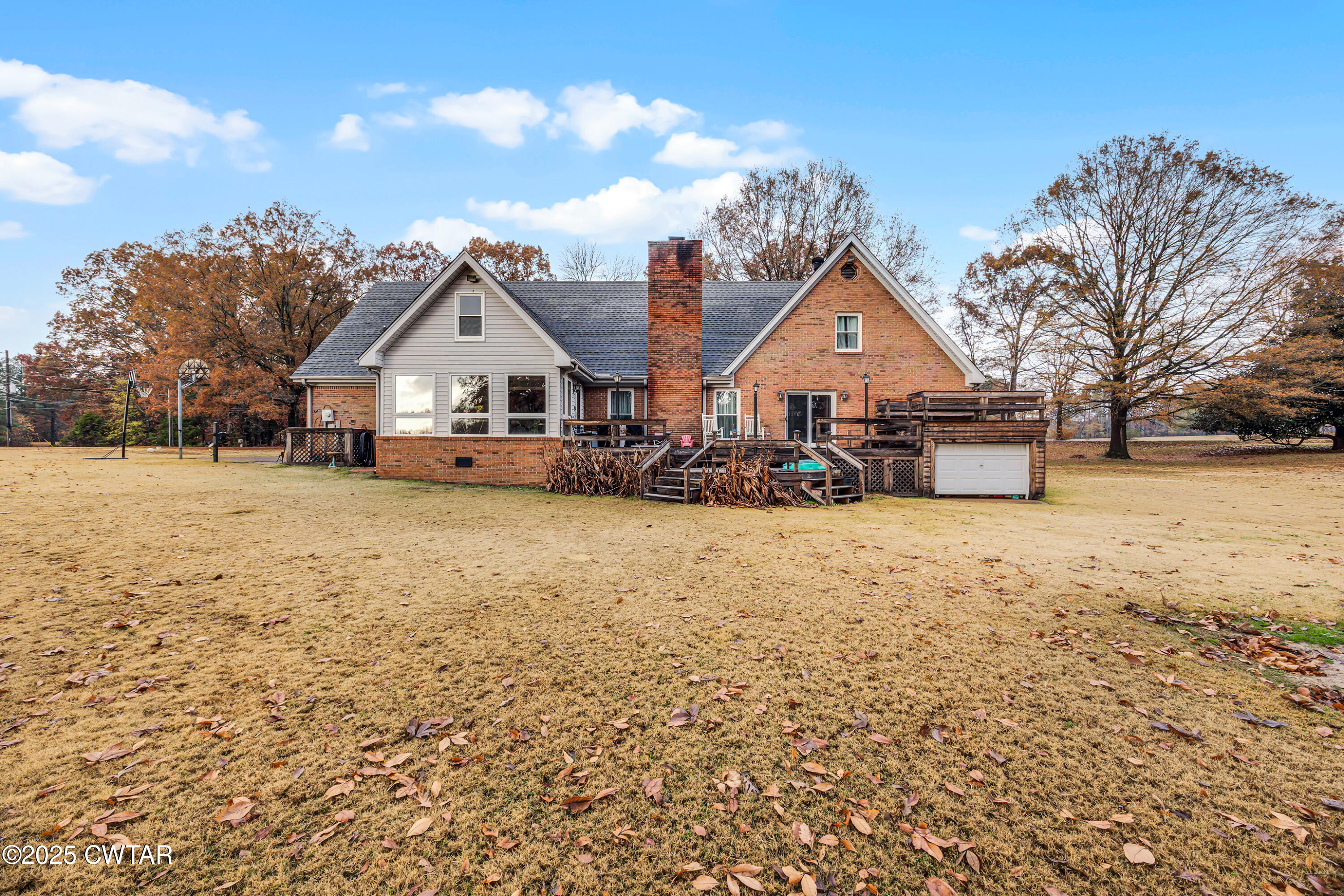 185 Bascom Road Jackson, TN 38305 - Photo 26 of 28 a view of a house with a yard covered with snow in front of house