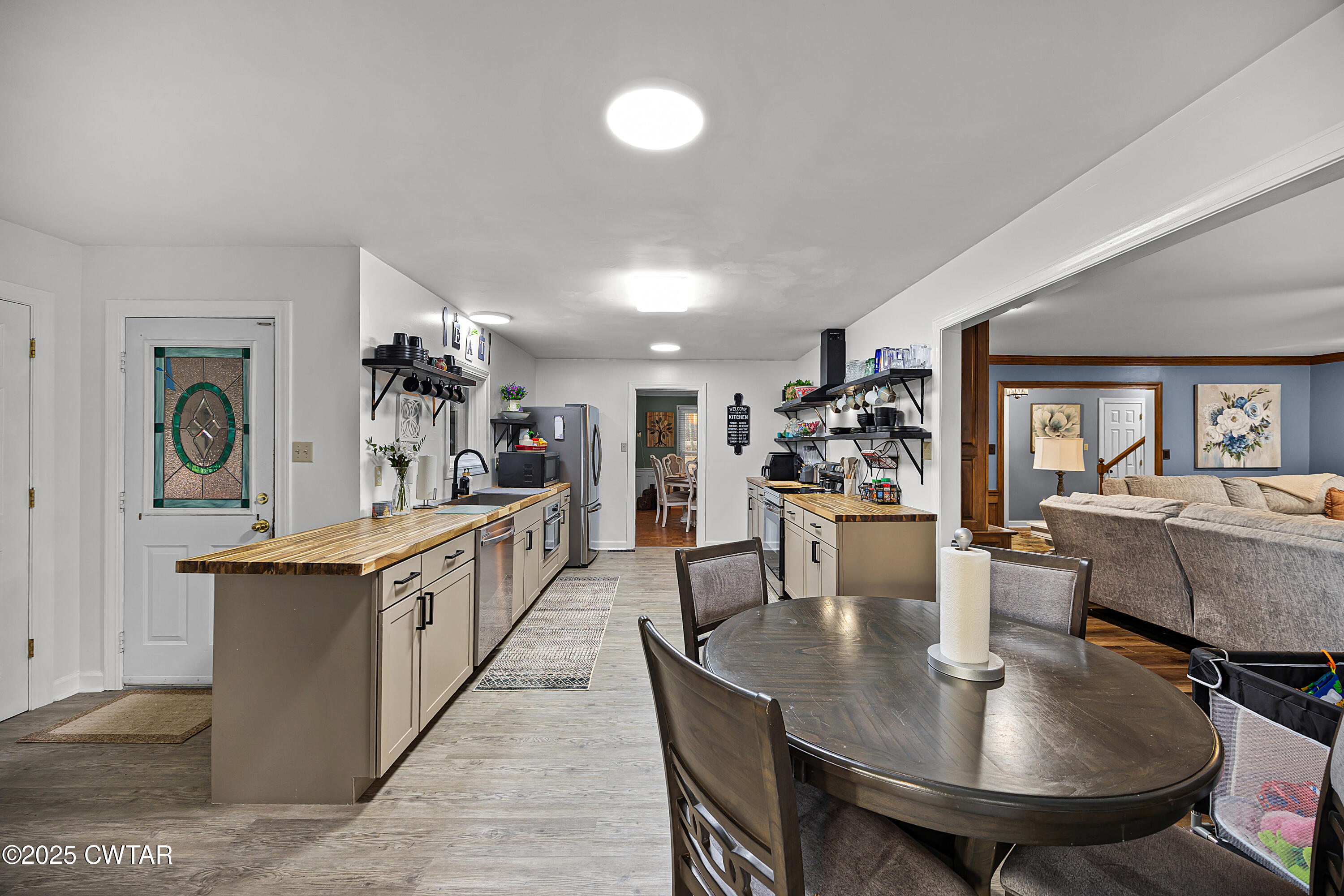 185 Bascom Road Jackson, TN 38305 - Photo 8 of 28 a kitchen with stainless steel appliances kitchen island granite countertop a table chairs and a refrigerator