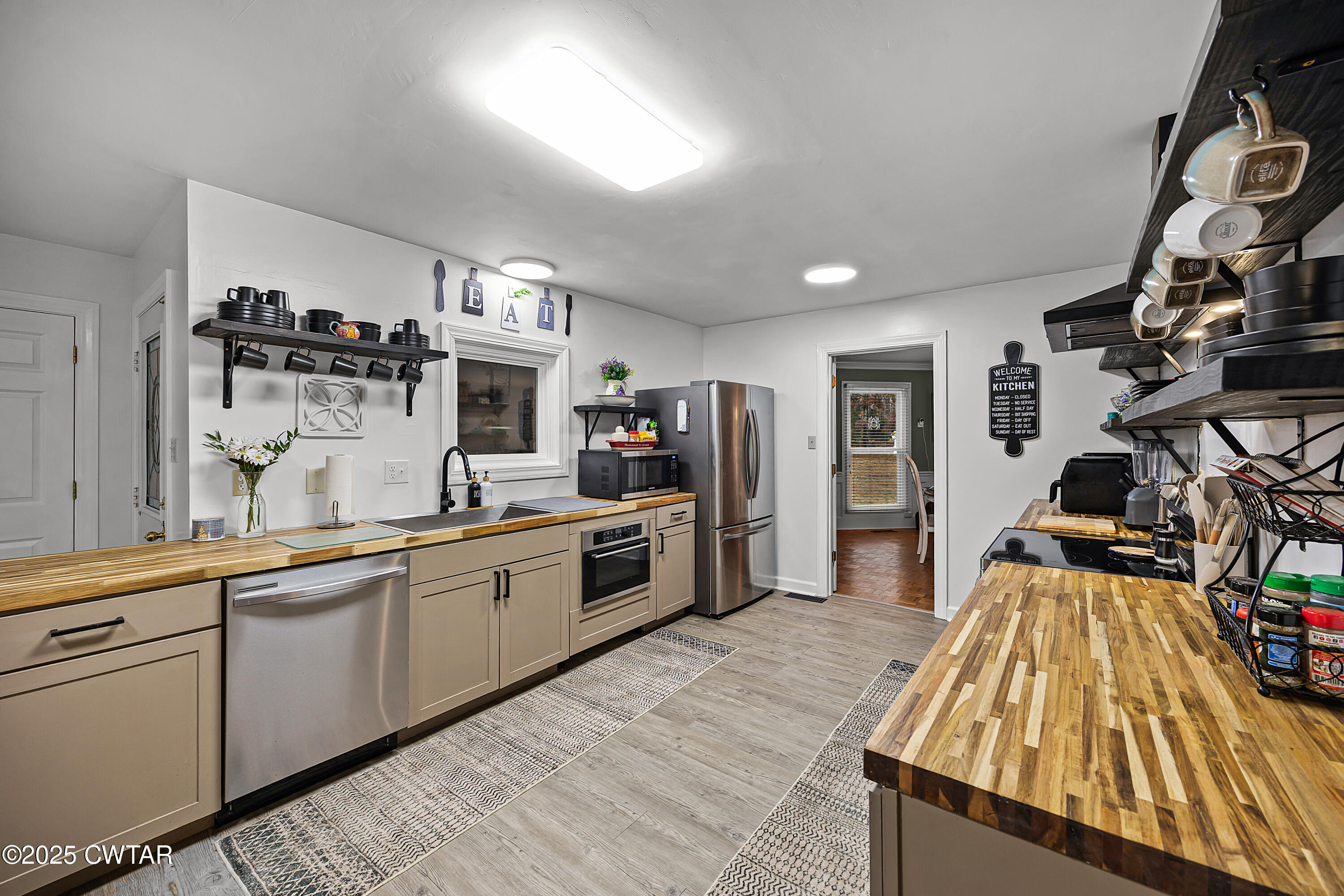 185 Bascom Road Jackson, TN 38305 - Photo 9 of 28 a large kitchen with cabinets and wooden floor