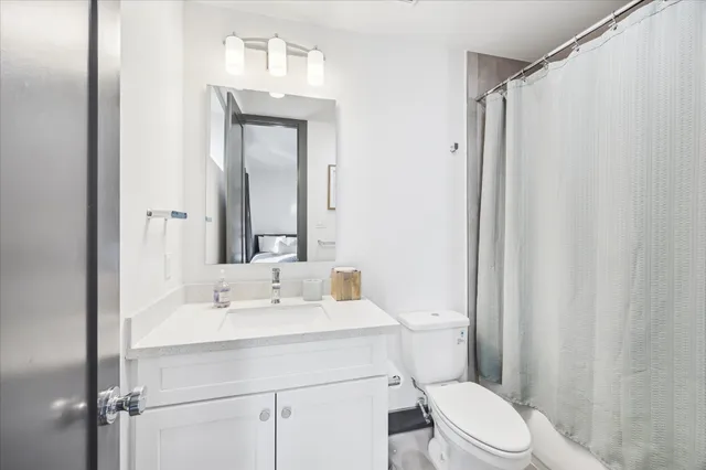 a white toilet sitting next to a bathroom sink