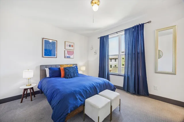 a bedroom with two beds and a flat screen tv