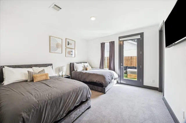a backyard of a house with table and chairs