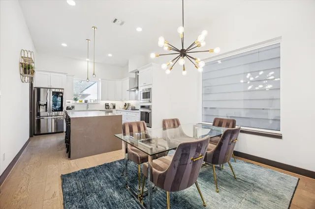 a spacious bedroom with a bed and a chandelier