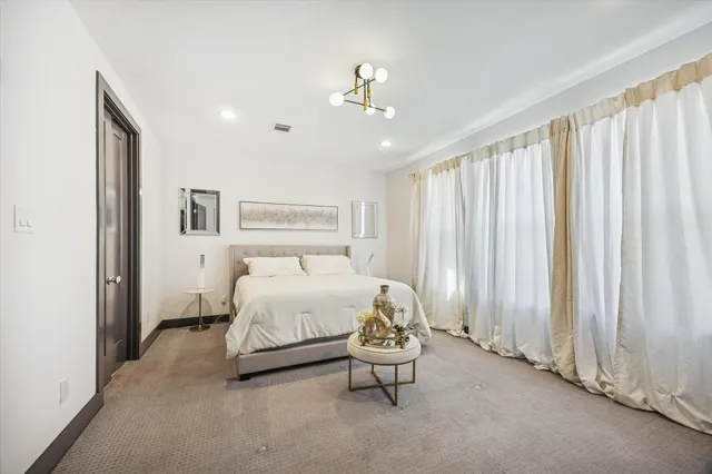 a spacious bathroom with a double vanity sink tub and mirror