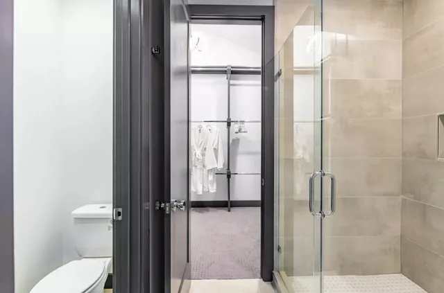 a view of walk in closet with empty racks