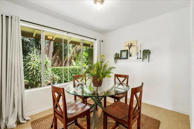 a dining room with furniture window and wooden floor