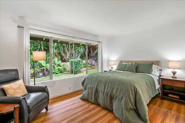 a bed sitting in a bedroom next to a window