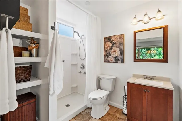 a bathroom with a toilet sink and shower