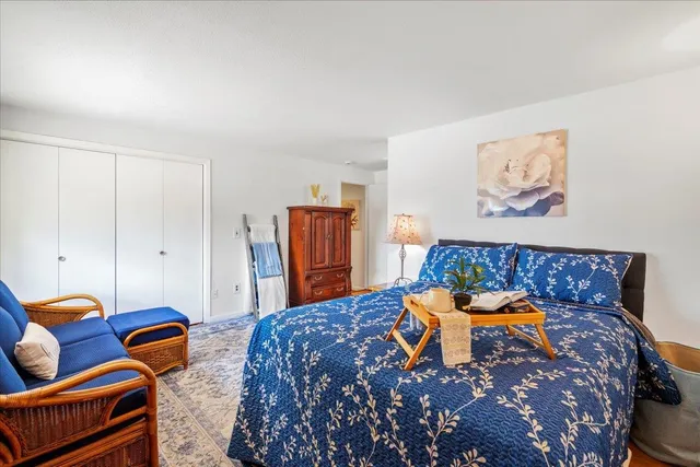 a bedroom with furniture and wooden floor