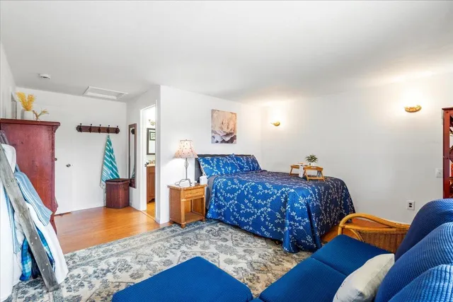 a living room with furniture rug and wooden floor