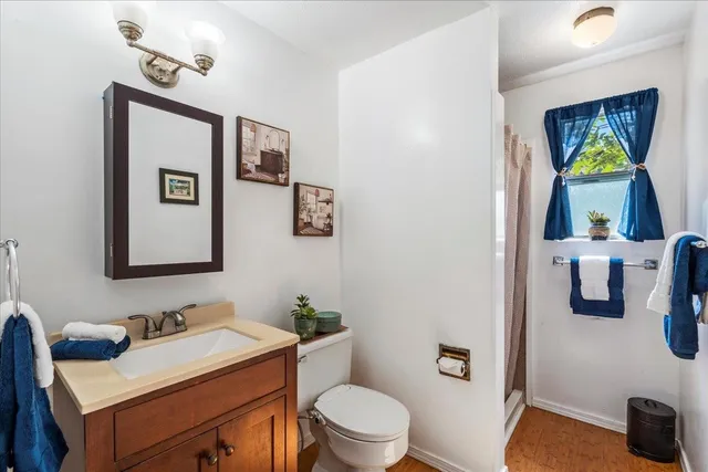 a bathroom with a toilet a sink and mirror