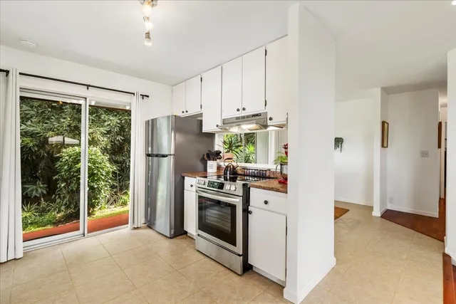 a kitchen with stainless steel appliances granite countertop a refrigerator a stove a sink and a refrigerator