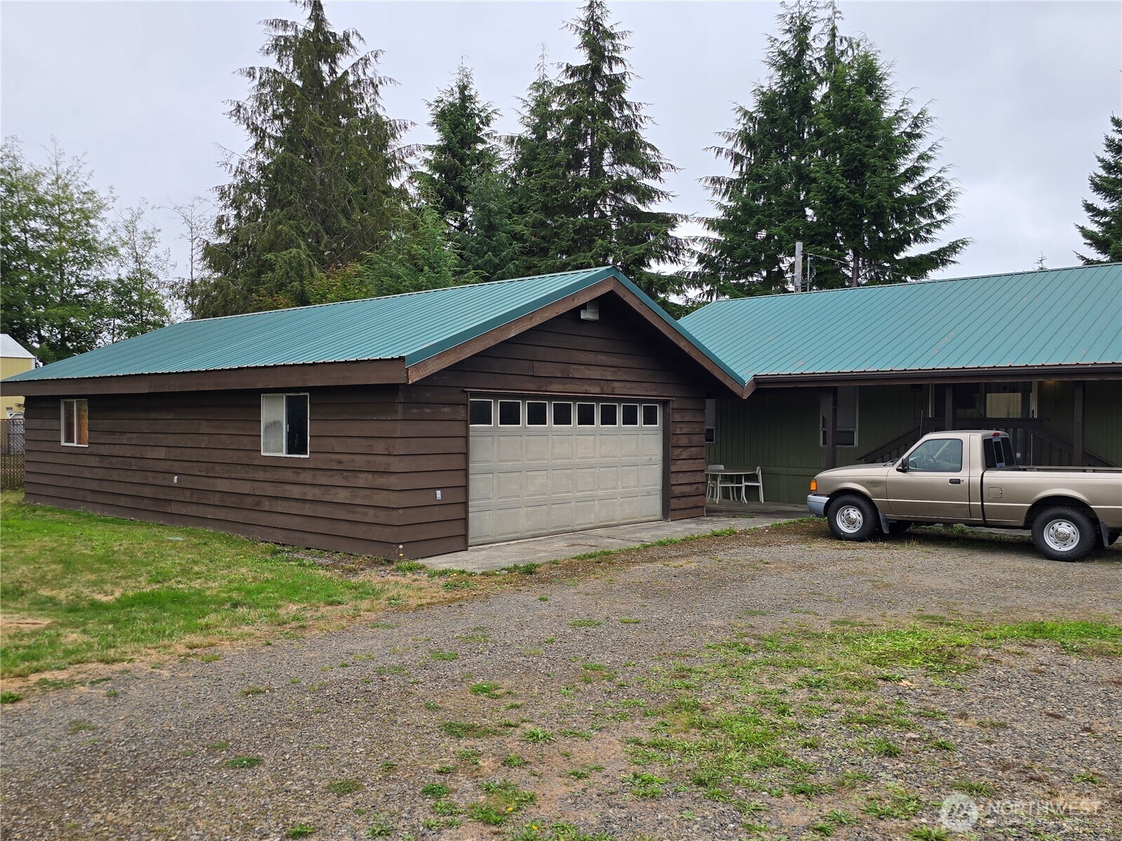 600 Russell Road Forks, WA 98331 - Photo 3 of 31 a front view of a house with a yard and garage