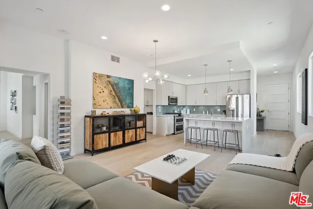 a living room with furniture and kitchen view