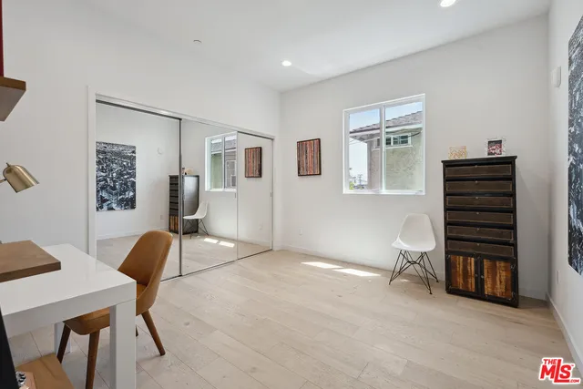 a bedroom with furniture and a chair