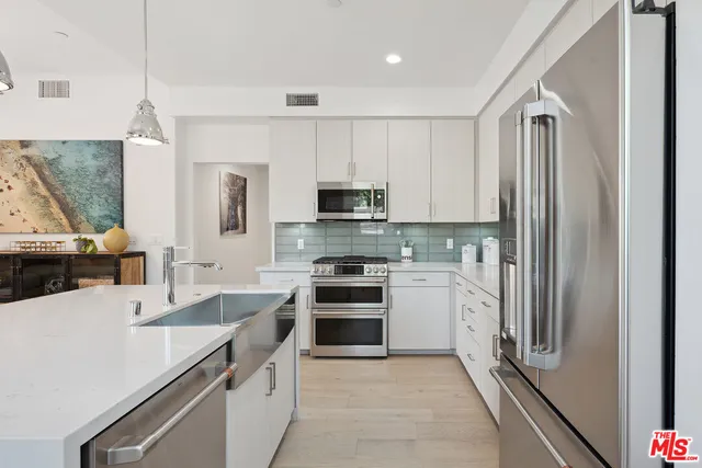 a kitchen with a sink stove and refrigerator