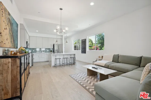 a living room with furniture and kitchen view