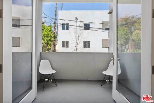 a view of a room with a table and chairs