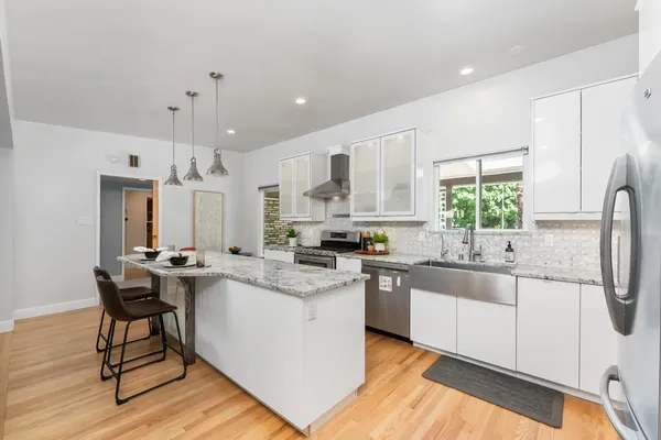 a kitchen with a sink a counter top space and appliances