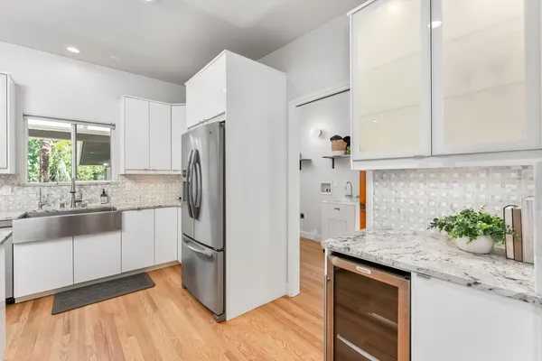 a kitchen with stainless steel appliances granite countertop a refrigerator and a sink