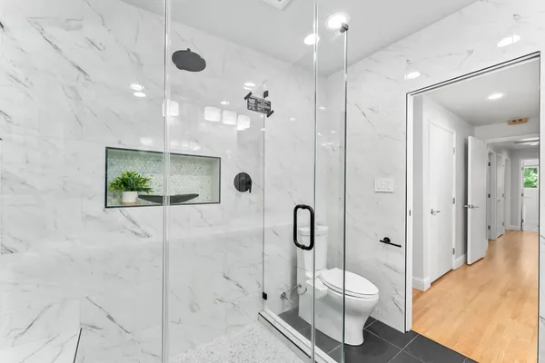 a bathroom with a toilet sink and shower