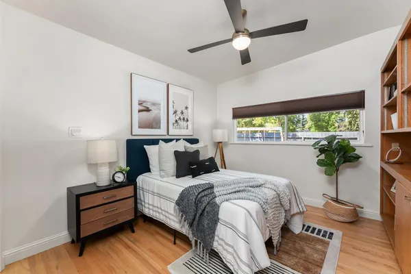 a bed room with a bed and a window