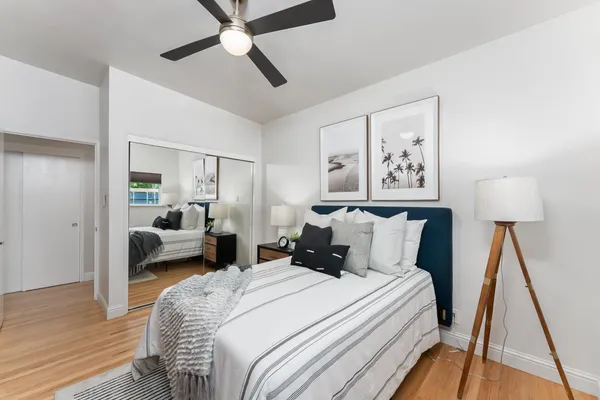 a bedroom with a bed and a mirror