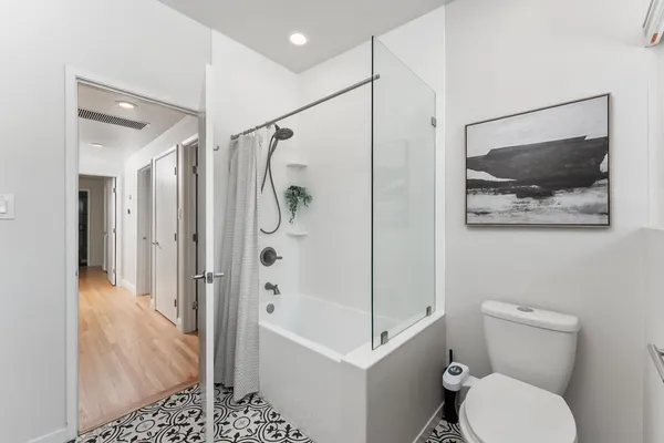 a bathroom with a shower toilet and sink