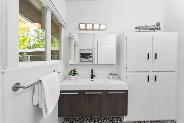 a sink with a mirror and a sink