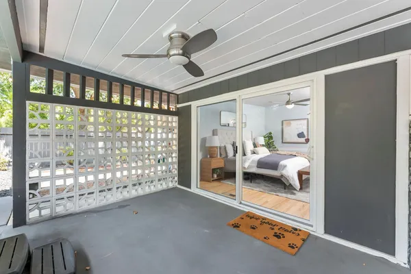 a bedroom with furniture and large window