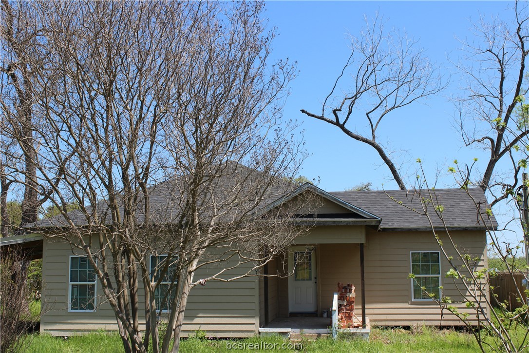 front view of a house with a trees