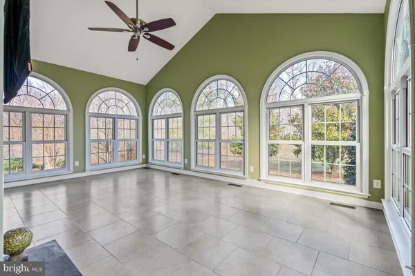 a living room with stainless steel appliances kitchen island granite countertop wooden floor and a view of living room