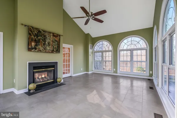 a kitchen with granite countertop a refrigerator stove microwave and cabinets