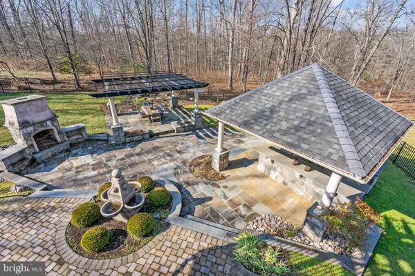a view of a backyard with table and chairs potted plants