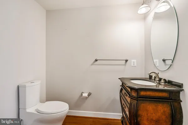 an empty room with windows and chandelier fan