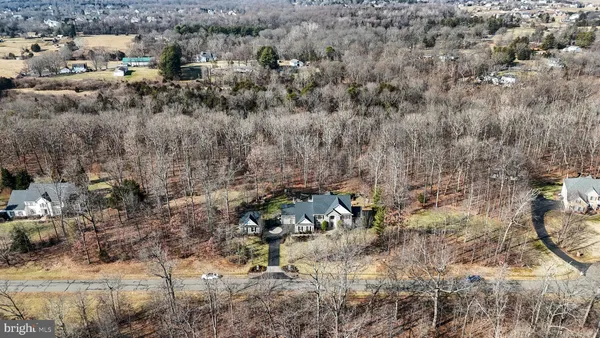 a view of a big house with a yard and plants