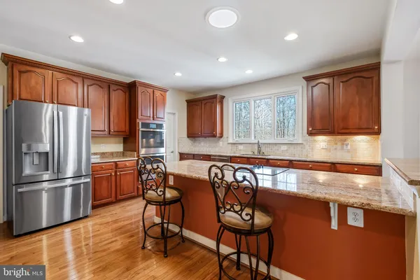 a view of an empty room with a chandelier fan