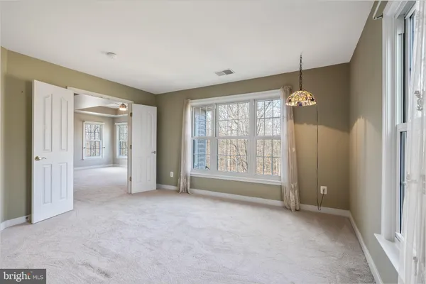 a view of a chairs and fire pit in backyard of the house