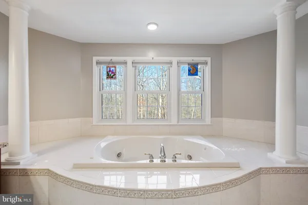 a view of a house with a big yard and sitting area