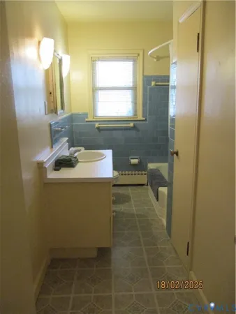 a bathroom with a sink a toilet and mirror