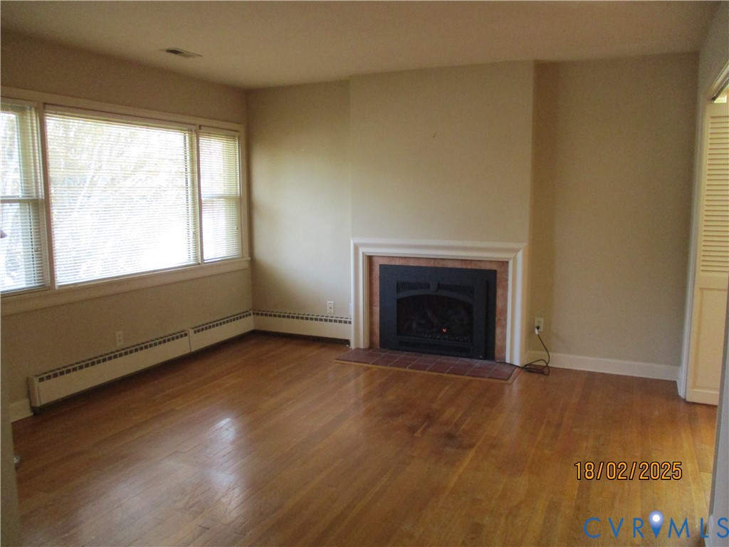 126 Beverly Road Ashland, VA 23005 - Photo 3 of 20 a view of an empty room with wooden floor and a window
