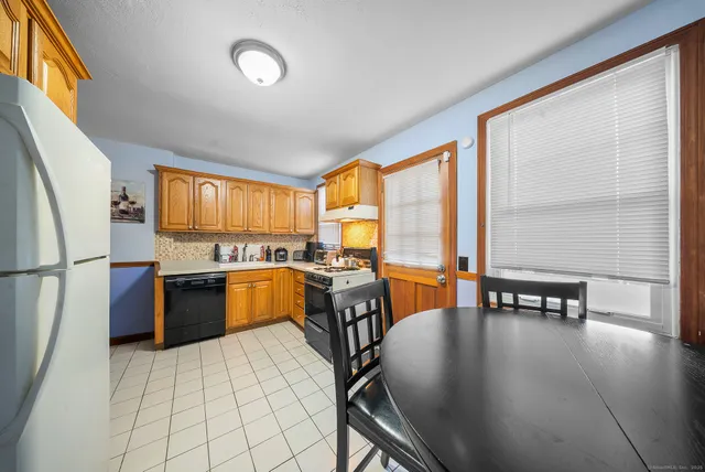 a dining room with furniture and large windows