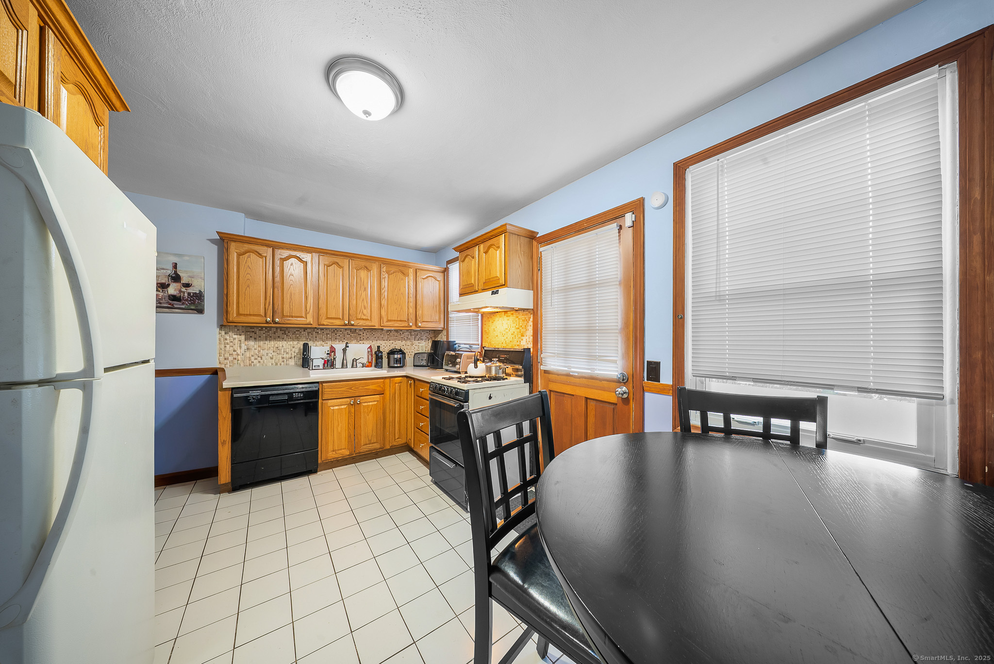 274 Sylvan Knoll Road Stamford, CT 06902 - Photo 8 of 21 a dining room with furniture and large windows