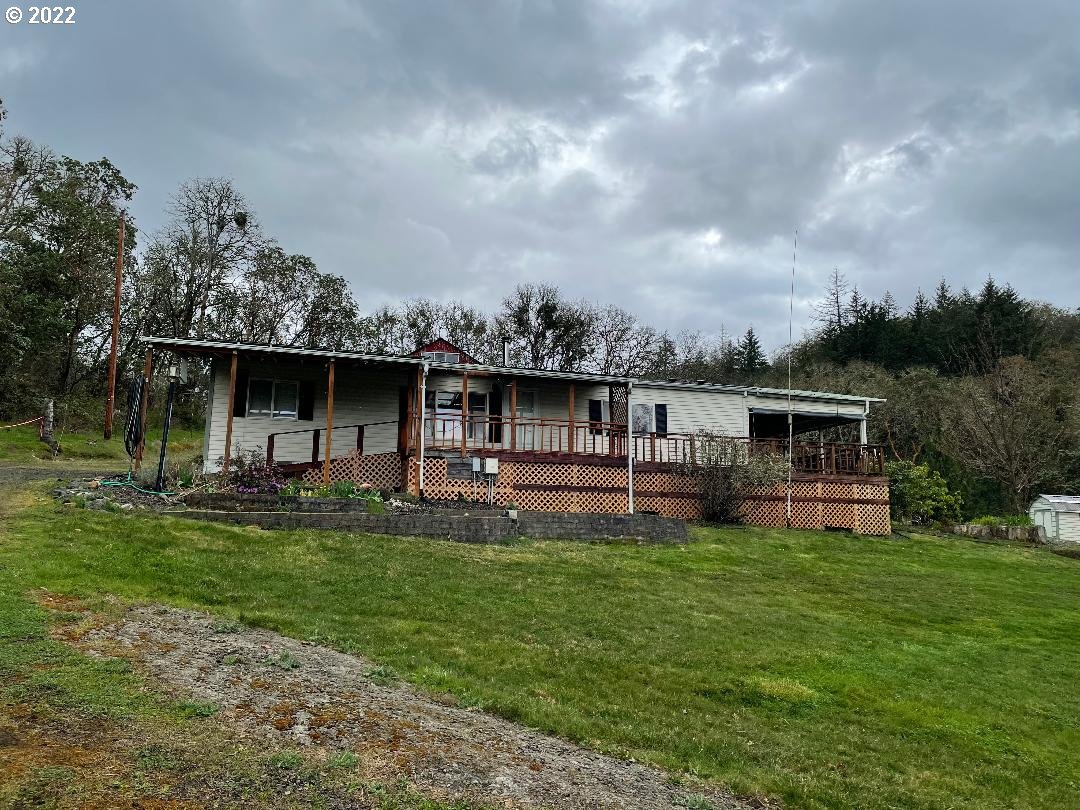 a front view of house with yard outdoor seating and green space